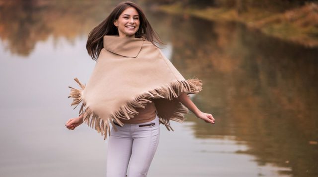 Young happy woman having fun near the river.