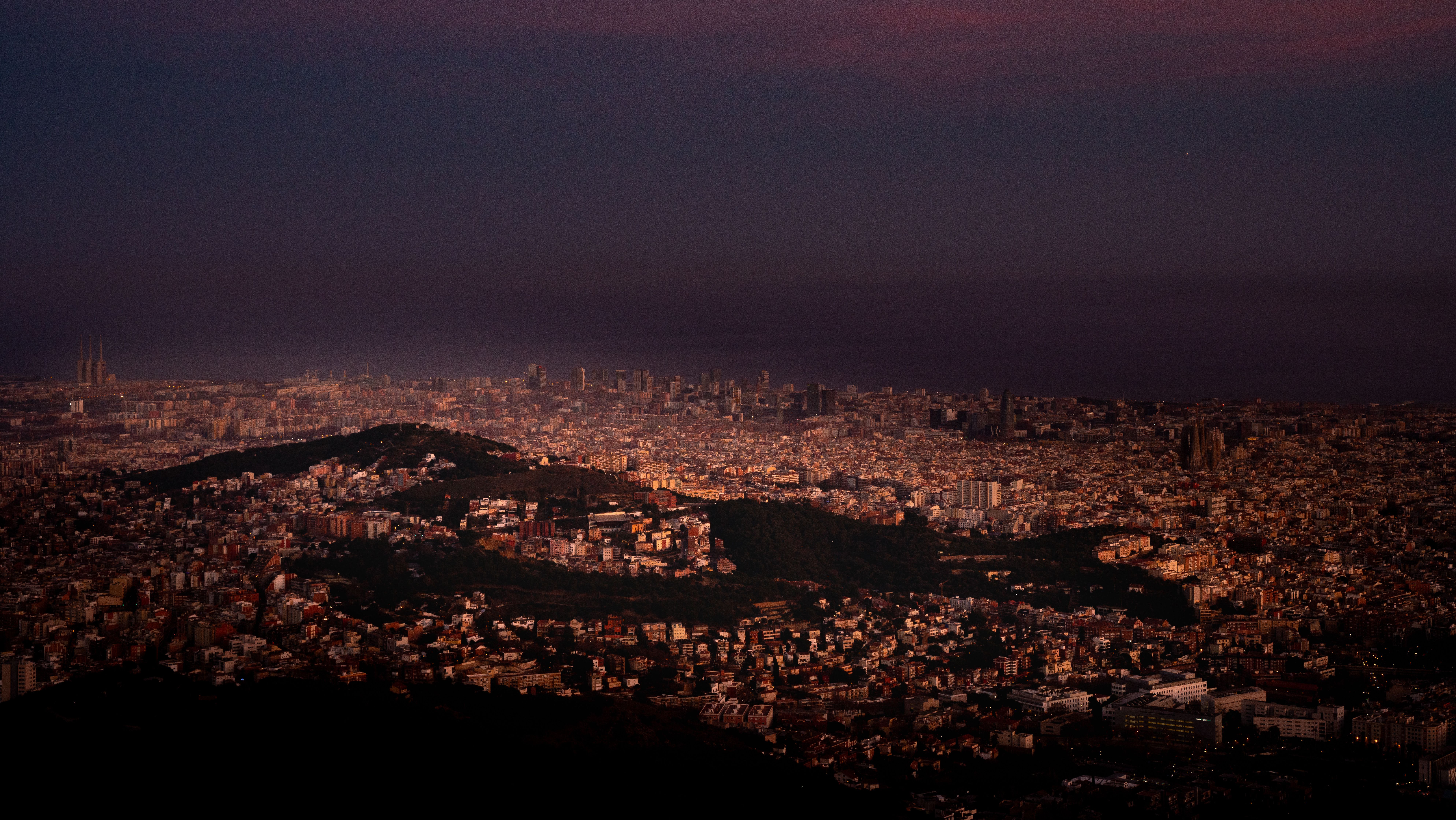 Barcelona illuminated at night, showing the city's vibrant urban landscape and nightlife atmosphere.
