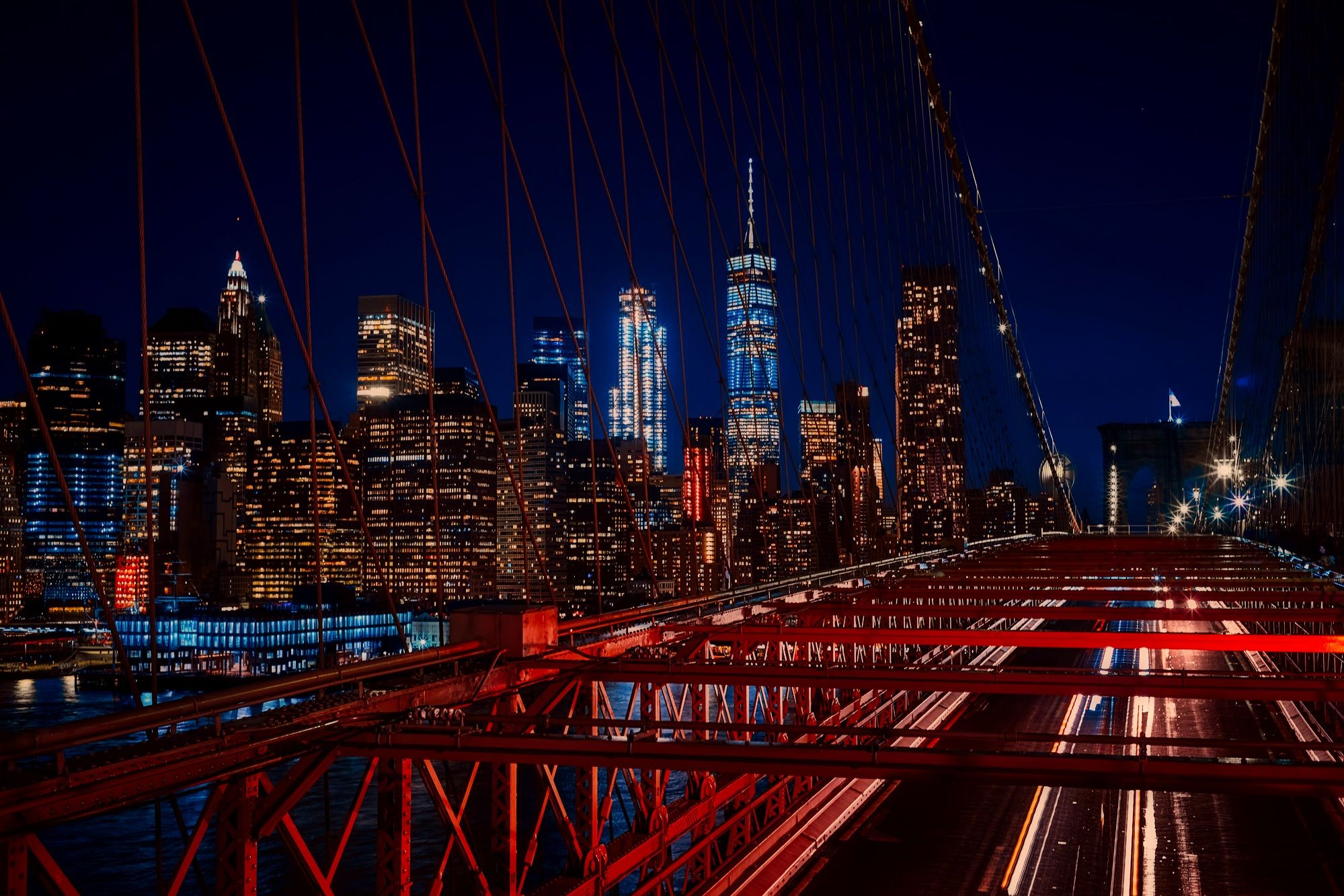 New York City skyline and Brooklyn Bridge illuminated at night