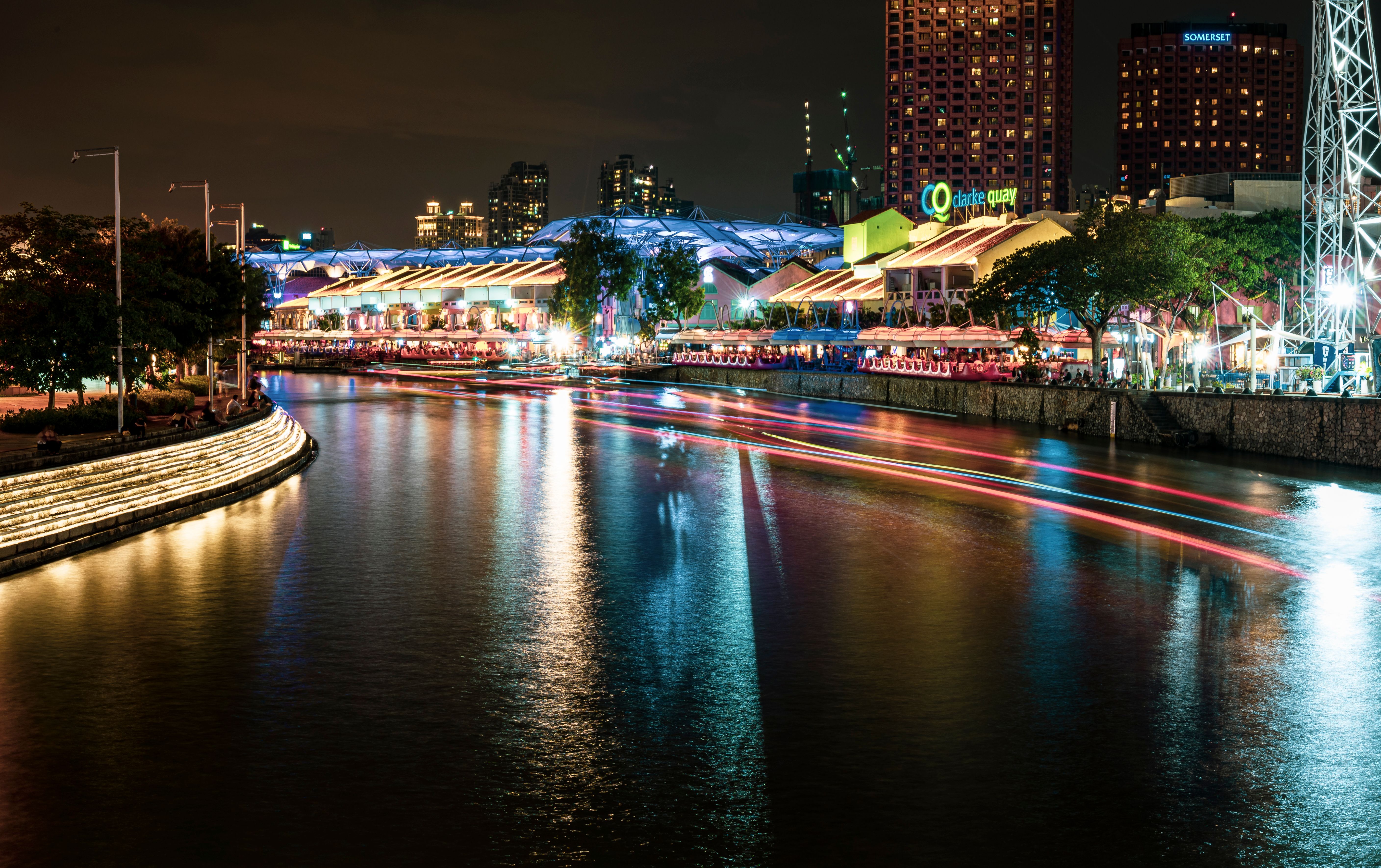 Colorful Clarke Quay waterfront in Singapore at night, a hub for dining and entertainment.